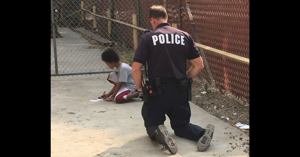 A Stockton, California, police officer helps a boy with autism.