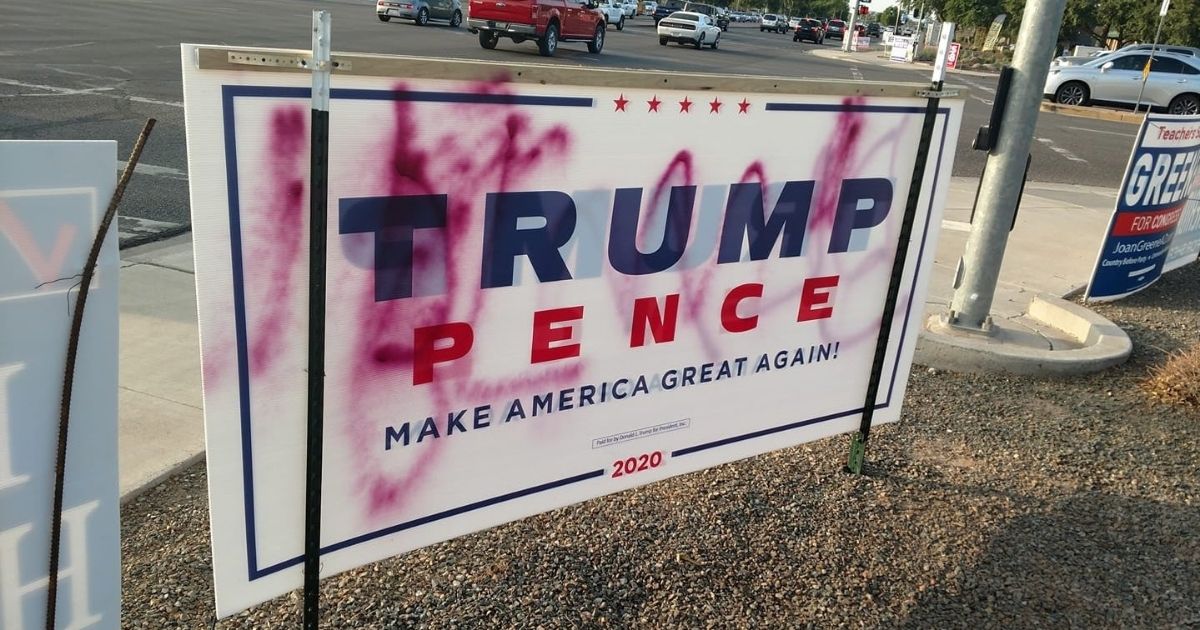 A campaign sign for President Donald Trump is defaced in Arizona.