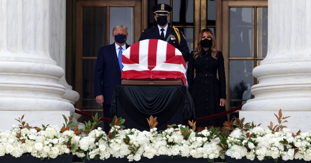 President Donald Trump and first lady Melania Trump pay their respects to Justice Ruth Bader Ginsburg's flag-draped casket on the Lincoln catafalque on the west front of the U.S. Supreme Court in Washington on Sept. 24, 2020.