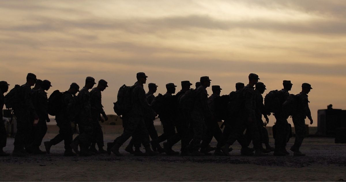 U.S. Army soldiers from the 2-82 Field Artillery, 3rd Brigade, 1st Cavalry Division, walk to where they will board buses to fly home to Fort Hood, Texas, after being one of the last American combat units to exit from Iraq on Dec. 15, 2011, at Camp Virginia, near Kuwait City, Kuwait.