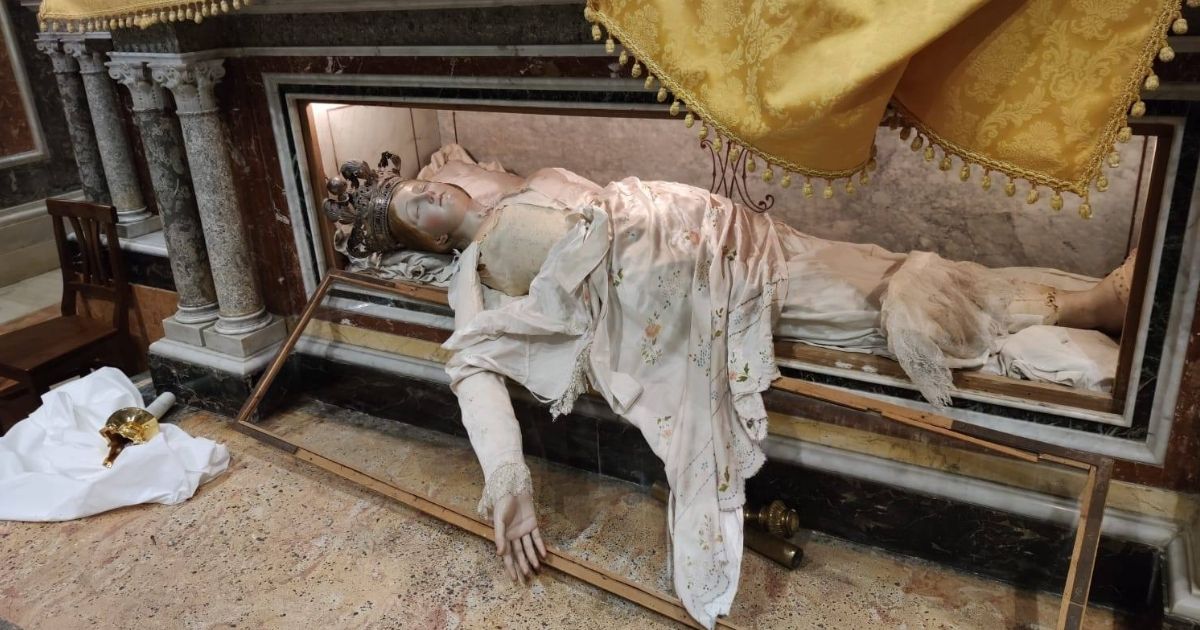A desecrated sleeping Madonna figure is seen in a Caltanissetta, Italy, church.