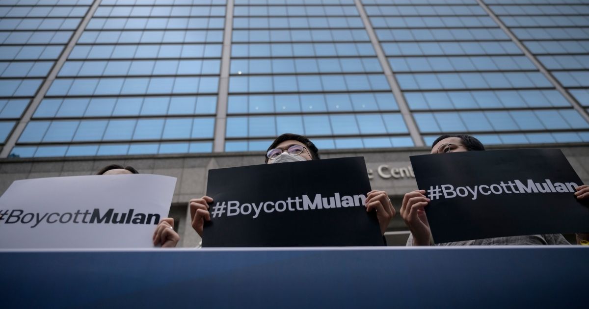 Protesters attend a rally against the release of the Disney movie 'Mulan' outside the company's office in Gangnam, in solidarity with Hong Kong's pro-democracy protests, in Seoul on July 1, 2020. - Hong Kong police made the first arrest under Beijing's new national security law as the city greeted the anniversary of its handover to China with protests banned and its cherished freedoms looking increasingly fragile.