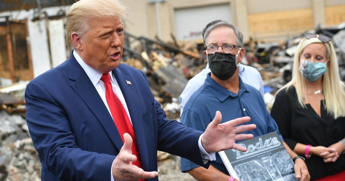 President Donald Trump speaks to the media amid the rubble in Kenosha, Wisconsin, on Sept. 1, 2020.