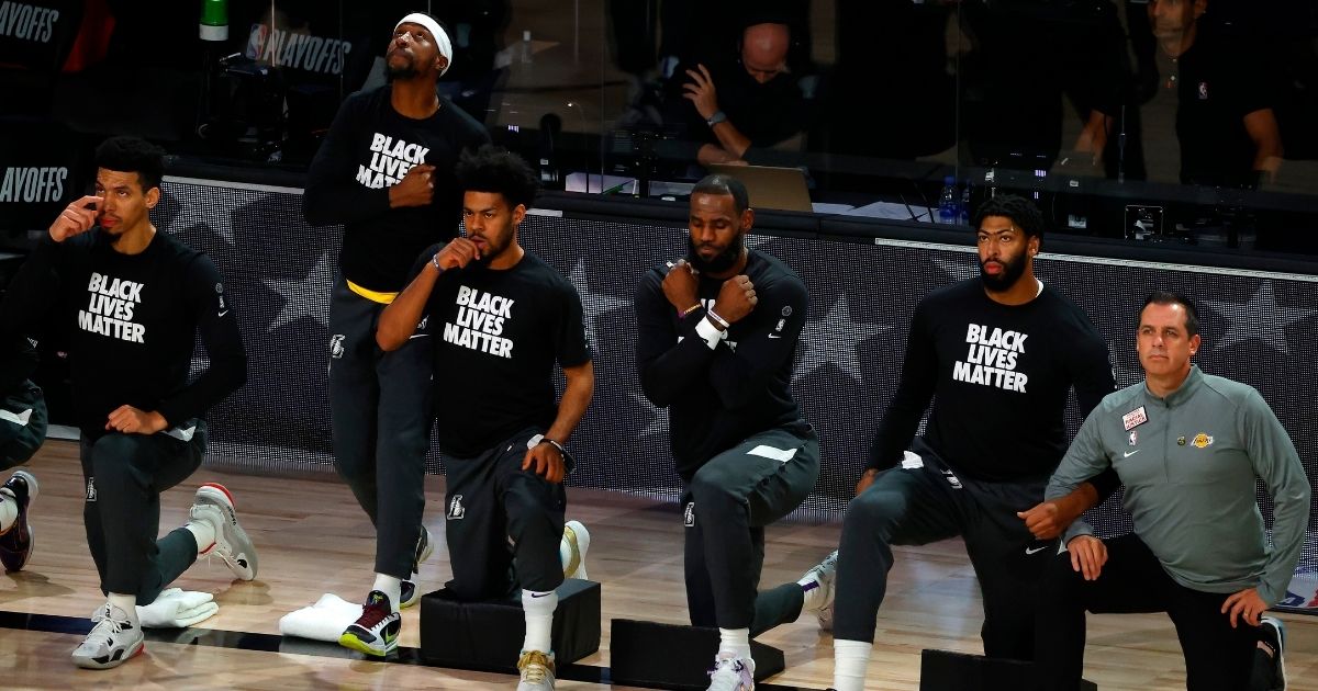 LeBron James, fourth from left, of the Los Angeles Lakers does the Wakanda salute during a moment of silence to honor the death of actor Chadwick Boseman before the start of Game Five of the Western Conference First Round against the Portland Trail Blazers during the 2020 NBA Playoffs at AdventHealth Arena on Aug. 29, 2020, in Lake Buena Vista, Florida.