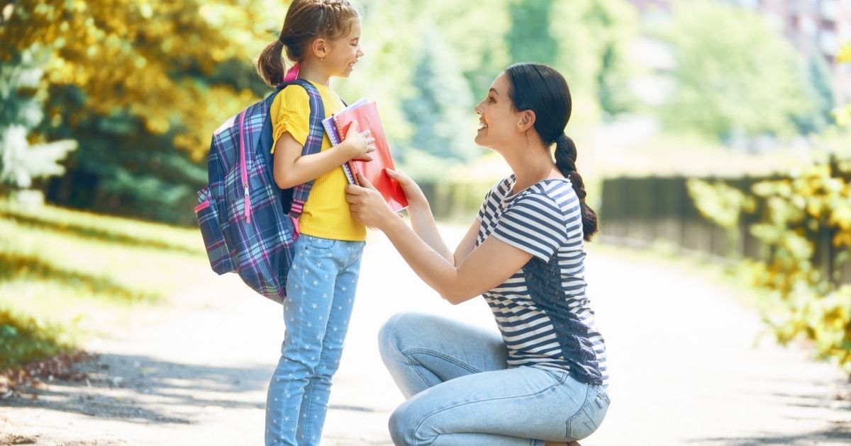 In the stock image above, a mother prepares her daughter for the first day of school.