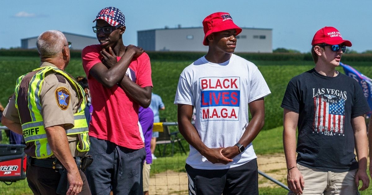 Supporters of President Donald Trump wear America-themed apparel on Aug. 17, 2020, in Mankato, Minnesota, as the president delivers remarks on jobs and the economy.