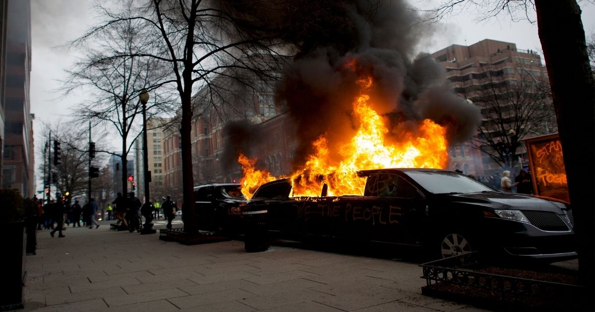 A limousine is set aflame with "We the People" spray-painted on the side after the inauguration of Donald Trump as the 45th president of the United States Jan. 20, 2016, in Washington, D.C.