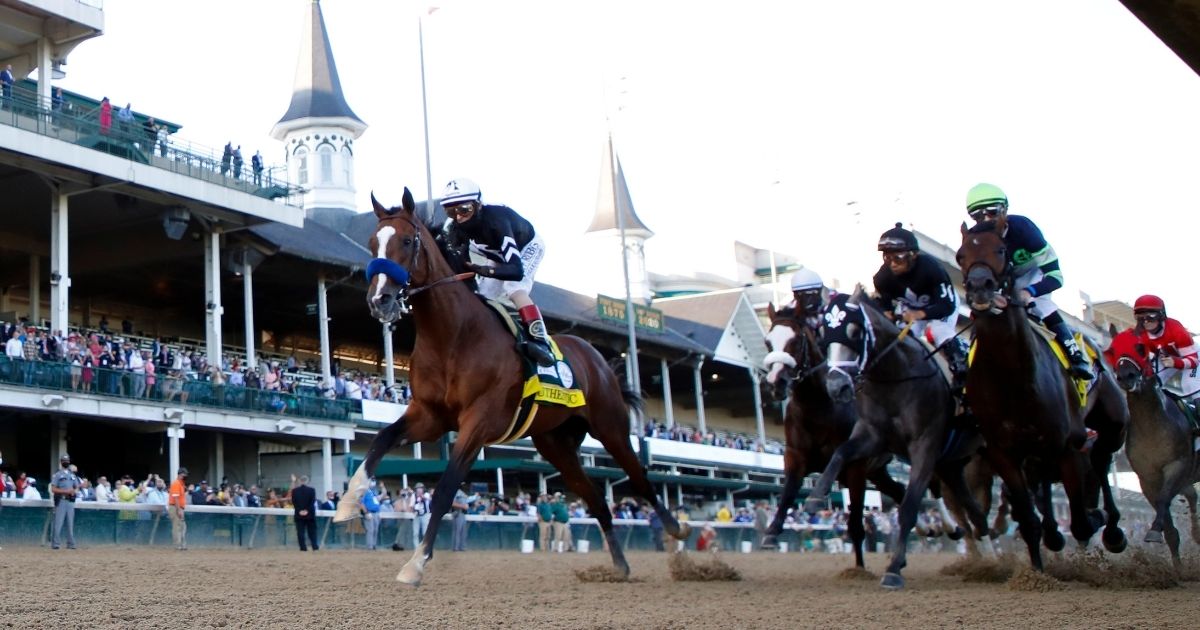 Authentic, #18, ridden by jockey John Velazquez, leads the field to the first turn during the 146th running of the Kentucky Derby at Churchill Downs on Sept. 5, 2020, in Louisville, Kentucky.