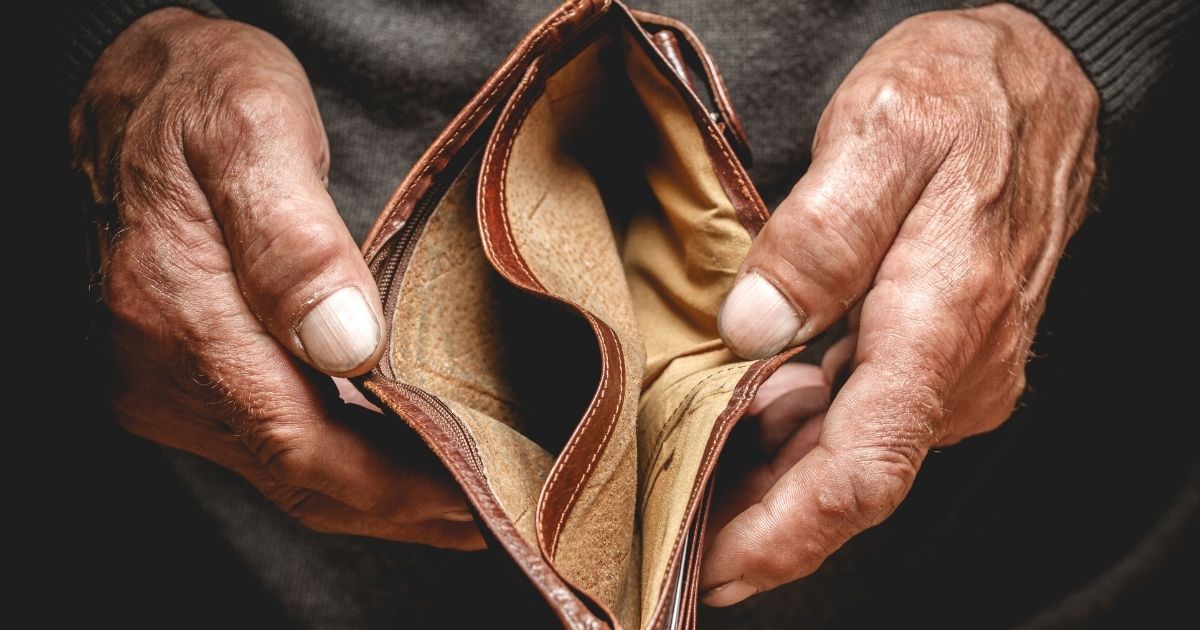 A stock image of an empty wallet in the hands of an elderly man is pictured above.