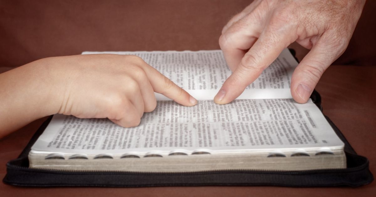 Two people studying the Bible are pictured in the stock image above.