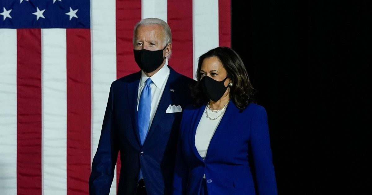 Democratic presidential nominee former Vice President Joe Biden and his running mate, California Sen. Kamala Harris, arrive to deliver remarks at the Alexis Dupont High School on Aug. 12, 2020, in Wilmington, Delaware.