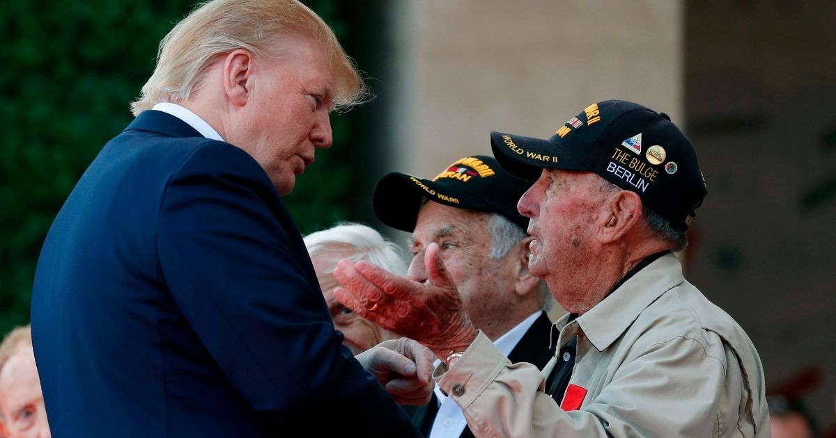 President Donald Trump greets a veteran during a French-U.S. ceremony at the Normandy American Cemetery and Memorial in Colleville-sur-Mer, France, on June 6, 2019, as part of D-Day commemorations marking the 75th anniversary of the World War II Allied landings in Normandy.