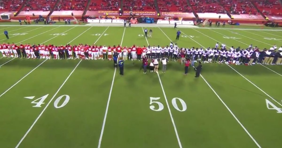 Players and coaches from the Houston Texans and Kansas City Chiefs gather midfield for a "moment of silence" before the first game of the 2020-2021 NFL season.