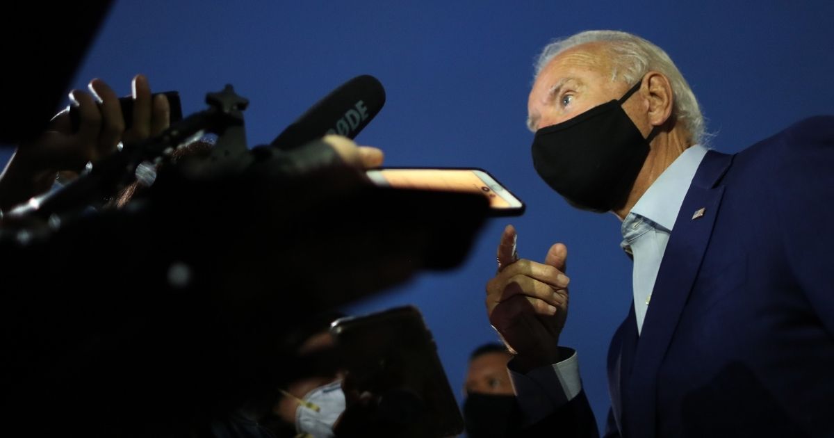 Democratic presidential nominee Joe Biden talks with journalists before departing the Detroit metro area on Sept. 9, 2020, in Romulus, Michigan.