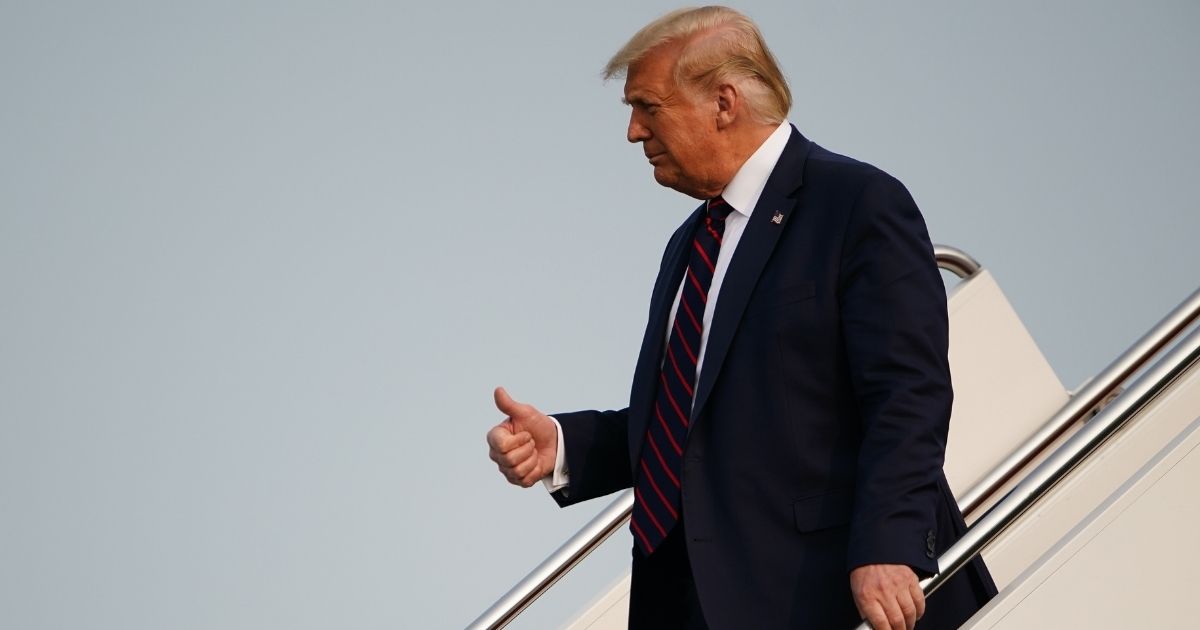 President Donald Trump gives a thumbs up as he steps off Air Force One upon arrival at Philadelphia International Airport in Philadelphia on Sept. 15, 2020.