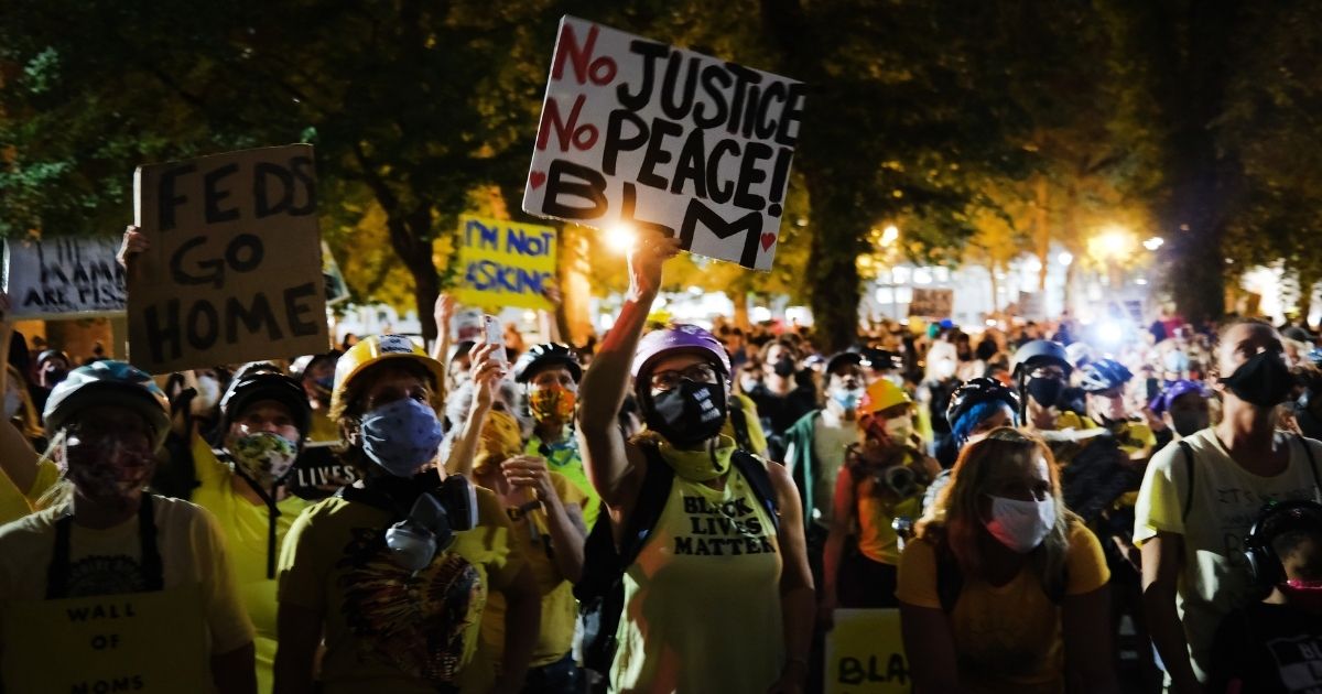 People gather to protest in front of the Mark O. Hatfield federal courthouse in downtown Portland, Oregon, as the city experiences another night of unrest on July 27, 2020.