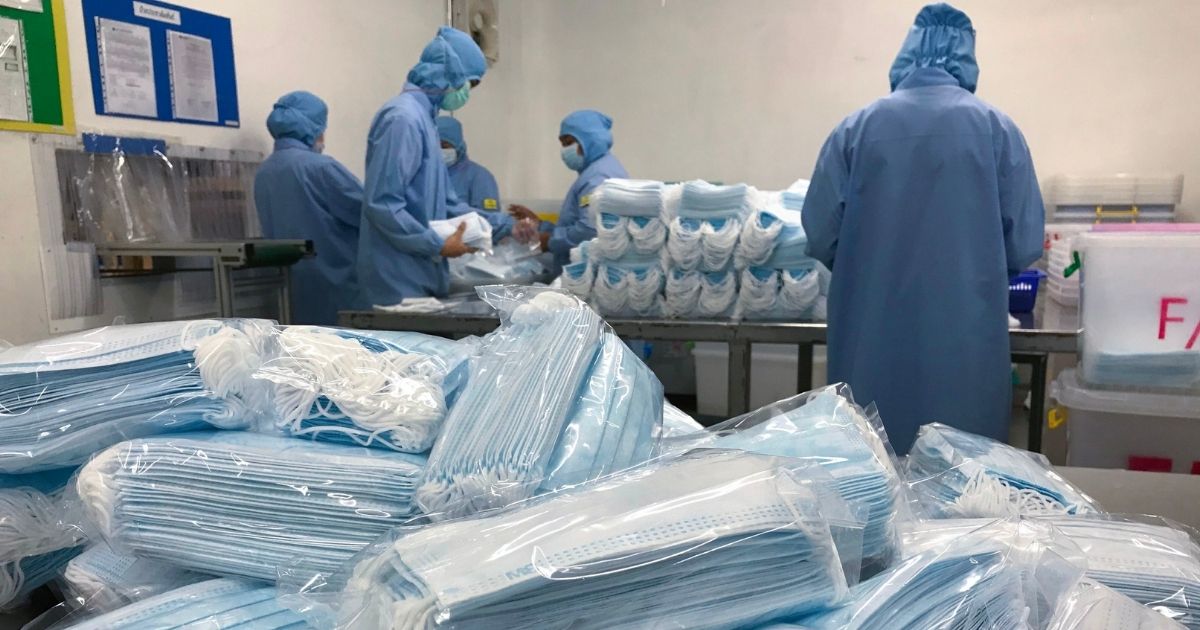 Workers produce masks at the Thai Hospital Product Company Ltd. factory in Bangkok on January 30, 2020. - A Thai surgical mask factory, producing 10 million masks a month, increased working hours to cope with the rising demand following an outbreak of SARS-like virus in China, with their product exported mostly to US and Europe the rest sold on the domestic market.