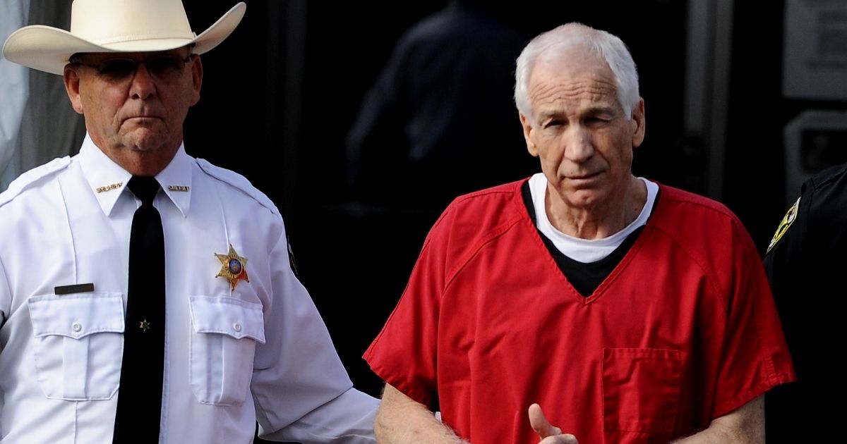 BELLEFONTE, PA - OCTOBER 09: Former Penn State assistant football coach Jerry Sandusky leaves the Centre County Courthouse after being sentenced in his child sex abuse case on October 9, 2012 in Bellefonte, Pennsylvania. The 68-year-old Sandusky was sentenced to at least 30 years and not more that 60 years in prison for his conviction in June on 45 counts of child sexual abuse, including while he was the defensive coordinator for the Penn State college football team.