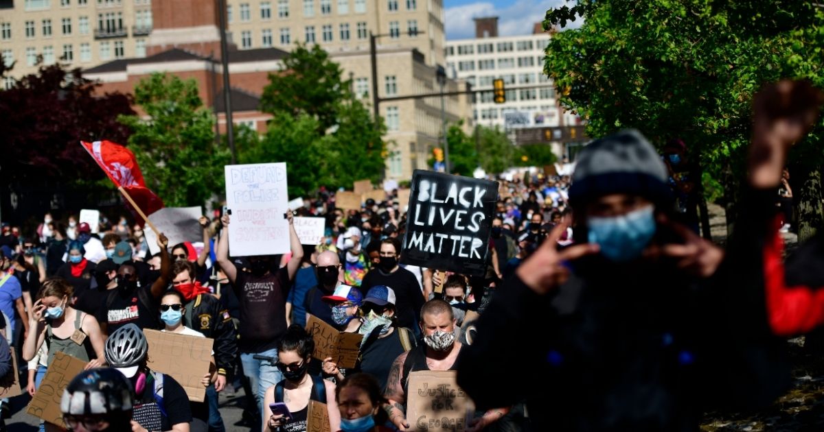 PHILADELPHIA, PA - JUNE 01: protesters with a "BLACK LIVES MATTER" sign march through Center City on June 1, 2020 in Philadelphia, Pennsylvania. Demonstrations have erupted all across the country in response to George Floyd's death in Minneapolis, Minnesota while in police custody a week ago.