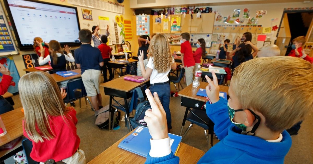 Students wear masks as a teacher instructs them at Freedom Preparatory Academy on September 10, 2020 in Provo, Utah. - In person schooling with masks has started up in many Utah schools since shutting down in March of this year due to the covid-19 virus.