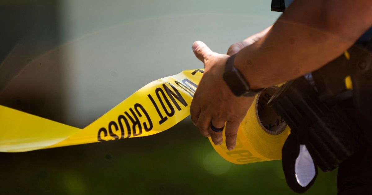 MINNEAPOLIS, MN - JUNE 16: A Minneapolis Police officers unrolls caution tape at a crime scene on June 16, 2020 in Minneapolis, Minnesota. The Minneapolis Police Department has been under increased scrutiny by residents and elected officials after the death of George Floyd in police custody on May 25.