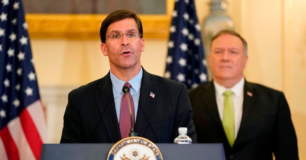 Defense Secretary Mark Esper speaks during a news conference as U.S. Secretary of State Mike Pompeo listens during the announcement of the Trump administration's restoration of sanctions on Iran on Monday at the State Department in Washington.