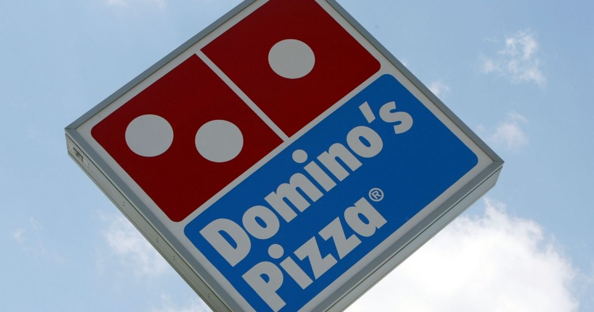 MIAMI, FL - APRIL 14: A sign in front of a Domino's Pizza April 14, 2004 in Miami, Florida. Domino's Pizza is looking to raise $300 million in the stock market by listing on the New York Stock exchange. The Michigan-based firm already has a London stock market listing for its UK subsidiary. According to media reports, the funds raised may be used to pay off debts. The 44-year-old firm now has 7,400 outlets in more than 50 countries. The firm is reporting that pizza sales are up 5.8% in 2003.