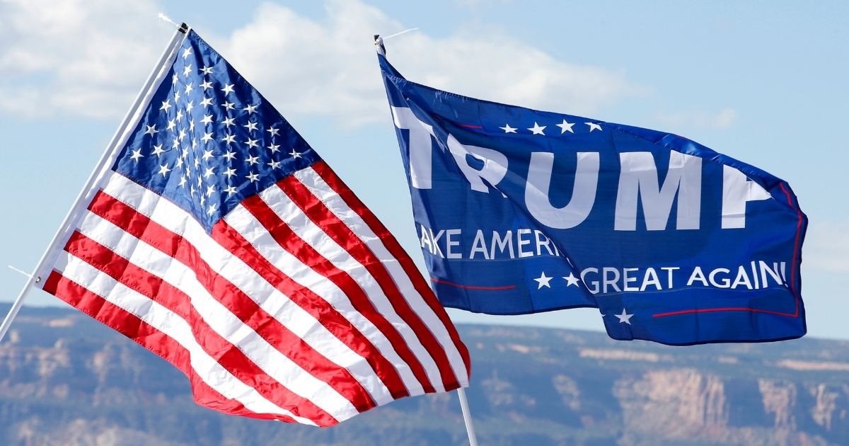 GRAND JUNCTION, CO - OCTOBER 18: With the Colorado National Monument in the background, an American flag and a Trump flag flies at a rally where Republican Presidential Candidate Donald Trump will speak on October 18, 2016 in Grand Junction, Colorado. Trump is on his way to Las Vegas for the third and final presidential debate against Democratic presidential candidate Hillary Clinton.