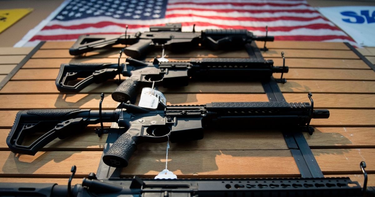 Assault rifles hang on the wall for sale at Blue Ridge Arsenal in Chantilly, Virginia, on October 6, 2017.