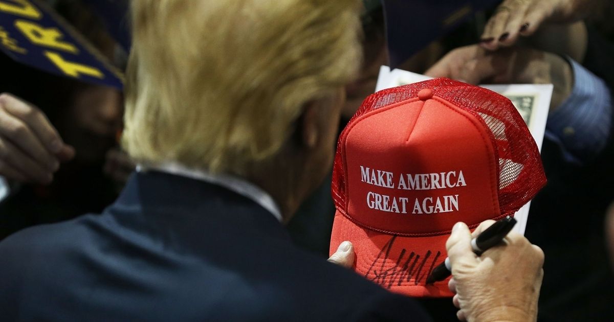 CEDAR FALLS, IA - JANUARY 12: Republican presidential candidate Donald Trump signs one of his campaign hats during a event at the University of Northern Iowa on January 12, 2016 in Cedar Falls, Iowa. Trump continues his quest to become the Republican presidential nominee.