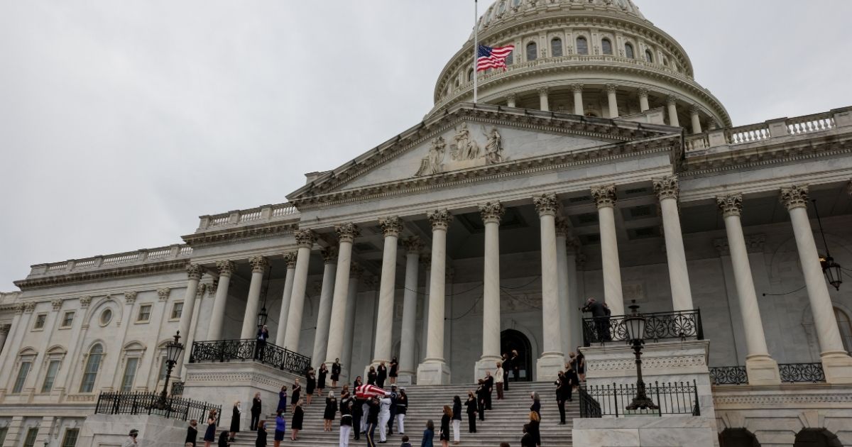 WASHINGTON, DC - SEPTEMBER 25: Female legislators look on as the casket of the late Supreme Court Associate Justice Ruth Bader Ginsburg is carried following ceremonies honoring Ginsburg at the U.S. Capitol on September 25, 2020 in Washington, DC. Ginsburg, who was appointed by former U.S. President Bill Clinton, served on the high court from 1993, until her death on September 18, 2020. She is the first woman to lie in state at the Capitol.