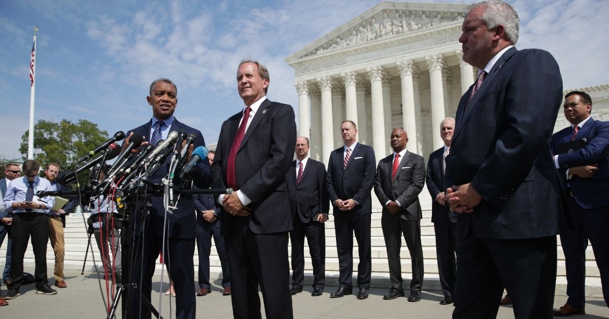 WASHINGTON, DC - SEPTEMBER 09: (L-R) Washington, DC Attorney General Karl Racine (L) speaks as Arkansas Attorney General Leslie Rutledge and Texas Attorney General Ken Paxton listens during a news conference in front of the U.S. Supreme Court September 9, 2019 in Washington, DC. Fifty state attorneys general are joining together to investigate Google’s possible antitrust violations.