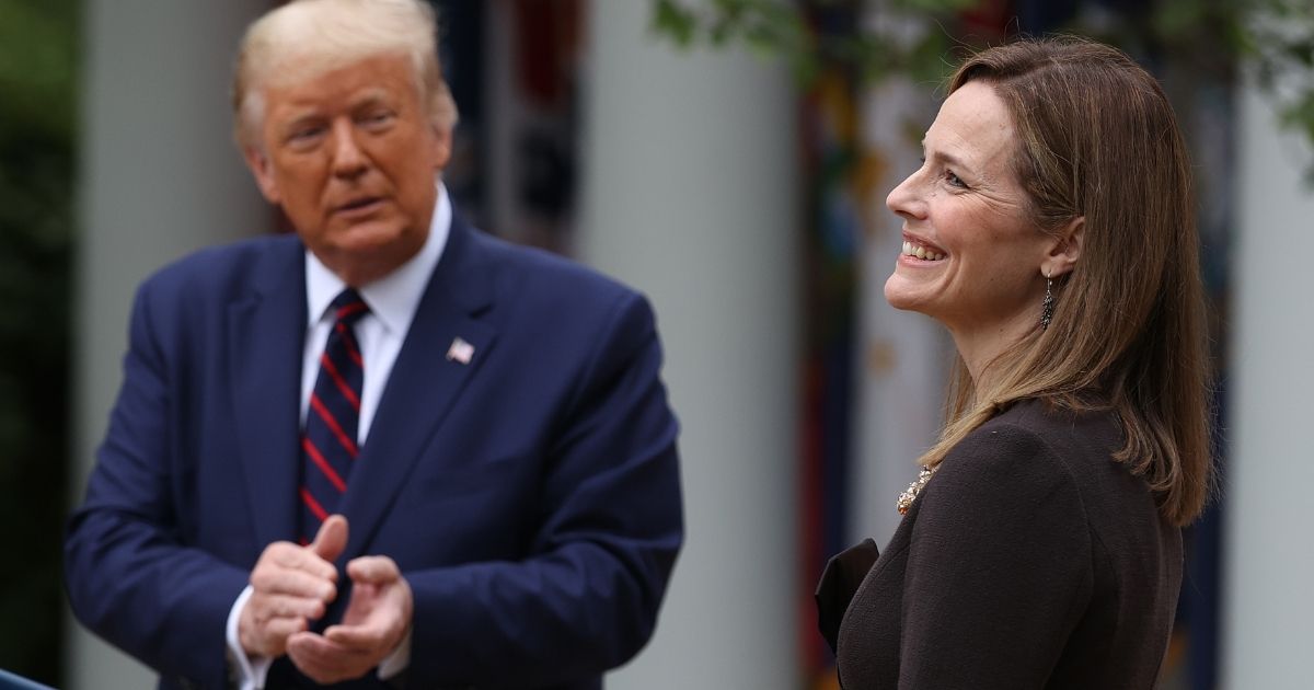 President Donald Trump applauds Saturday after introducing federal Judge Amy Coney Barrett as his nominee for the Supreme Court.