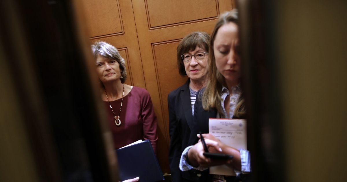 WASHINGTON, DC - OCTOBER 02: Sen. Lisa Murkowski (R-AK) (L) and Sen. Susan Collins (R-ME) share an elevator as they head for the weekly Senate Republican policy luncheon at the U.S. Capitol October 02, 2018 in Washington, DC. Senate GOP leaders agreed last week with the Judiciary Committee to allow the FBI to conduct a one-week investigation into sexual assault allegations against Supreme Court nominee Judge Brett Kavanaugh before the Senate votes on his confirmation.