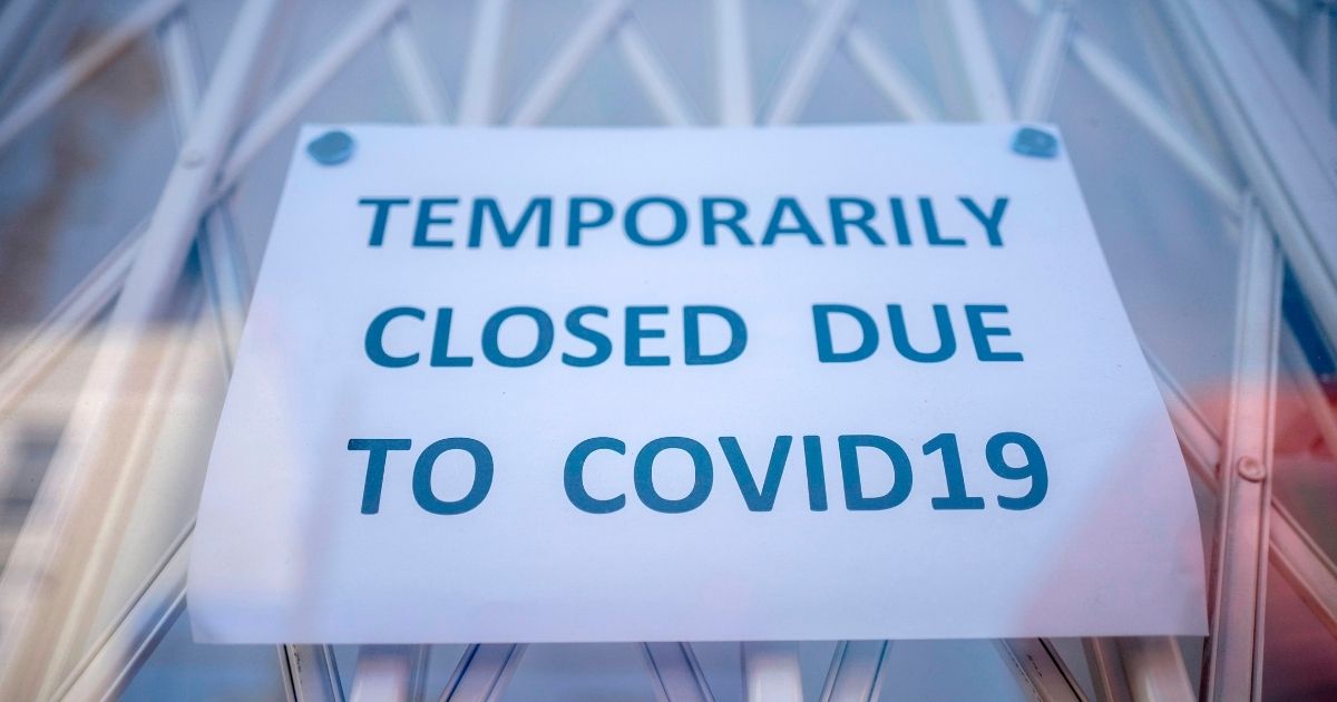 TOPSHOT - A sign is seen in the window of a shop explaining to customers that it has temporarily closed due to the coronavirus outbreak in Portobello Market in west London on June 1, 2020, following the easing of the lockdown restrictions during the novel coronavirus pandemic. - Some non-essential stores, car dealerships and outdoor markets in Britain on June 1 were able to reopen from their COVID-19 shutdown in an easing of coronavirus lockdown measures.