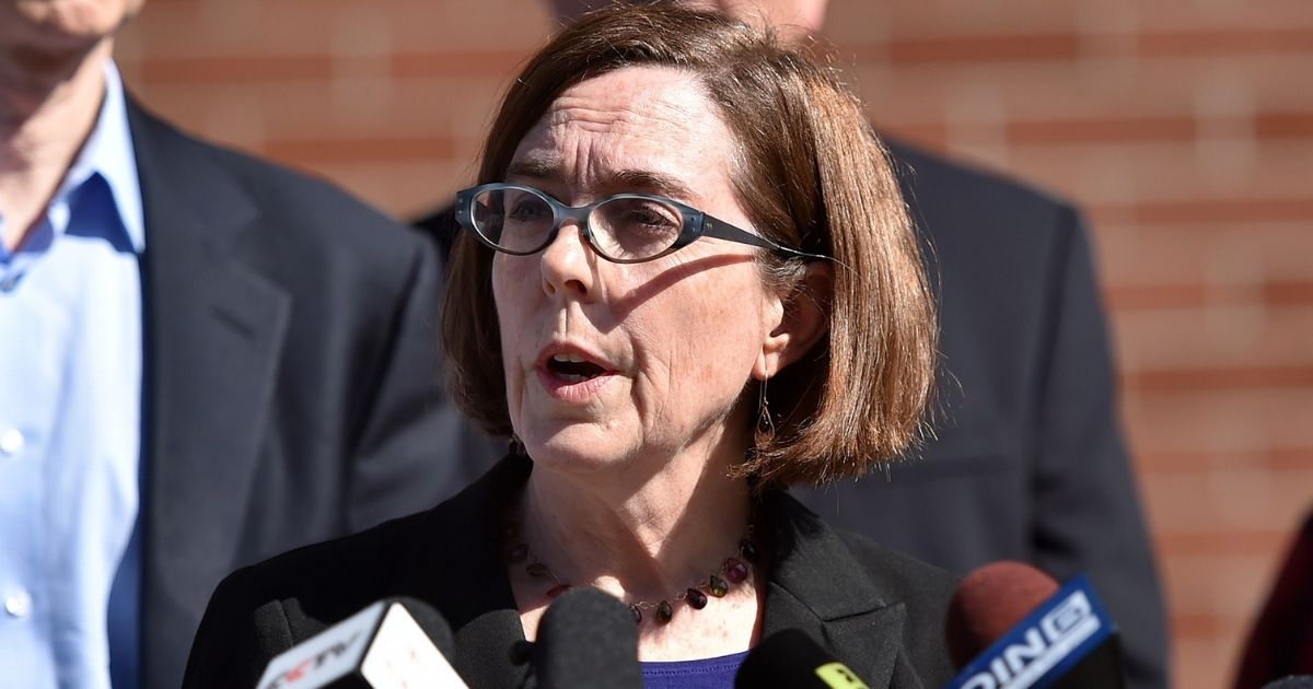 Oregon Governor Kate Brown reacts during a press conference in Roseburg, Oregon on October 2, 2015. As police and mourners groped for answers in the latest carnage to hit gun-crazed America, a portrait started to emerge Friday of the Oregon community college shooter: an angry recluse who hated religion. The rampage Thursday by a heavily armed young man identified as Chris Harper Mercer, 26, left 10 dead and shattered a close-knit rural community in the south of the state.