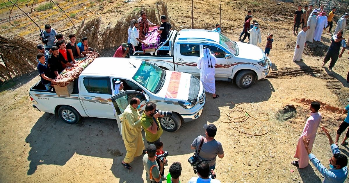 Mourners escort coffins of civilians killed by a Katyusha rocket attack near the international airport in Baghdad on Tuesday.