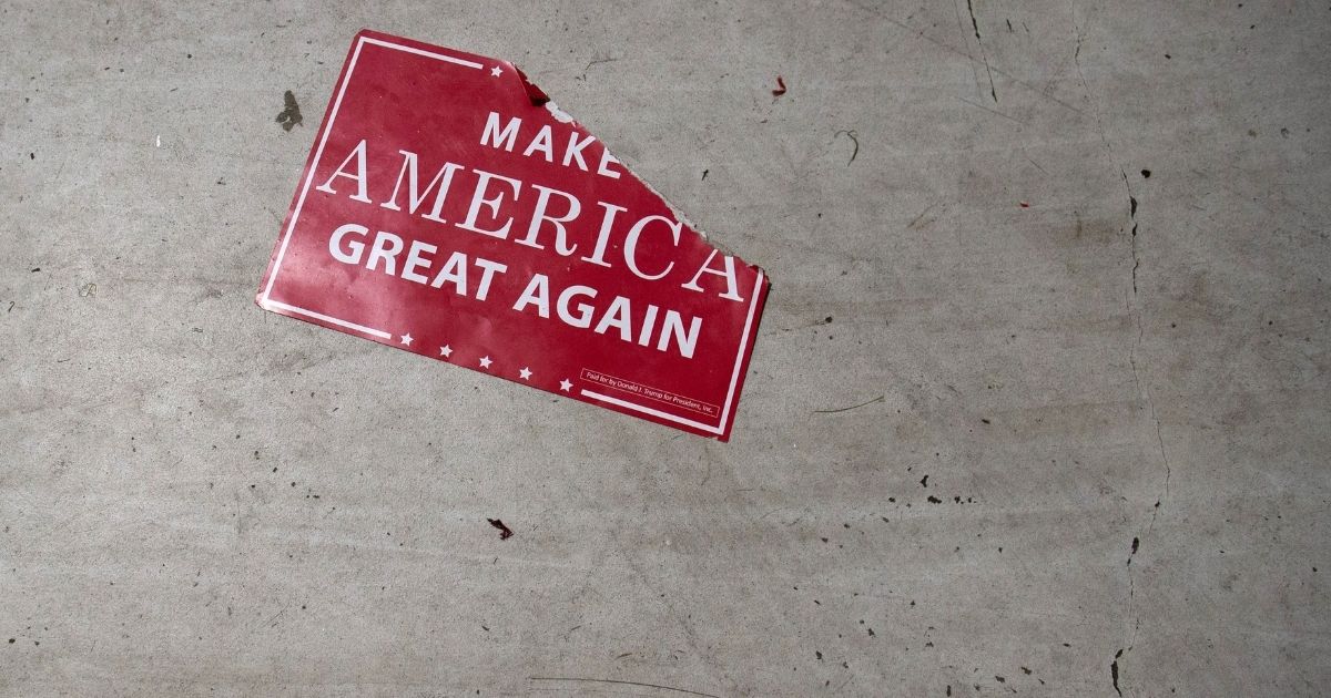 A "Make America Great Again" sign sits on the floor following a campaign rally with the US president at Central Wisconsin Airport in Mosinee, Wisconsin, October 24, 2018.