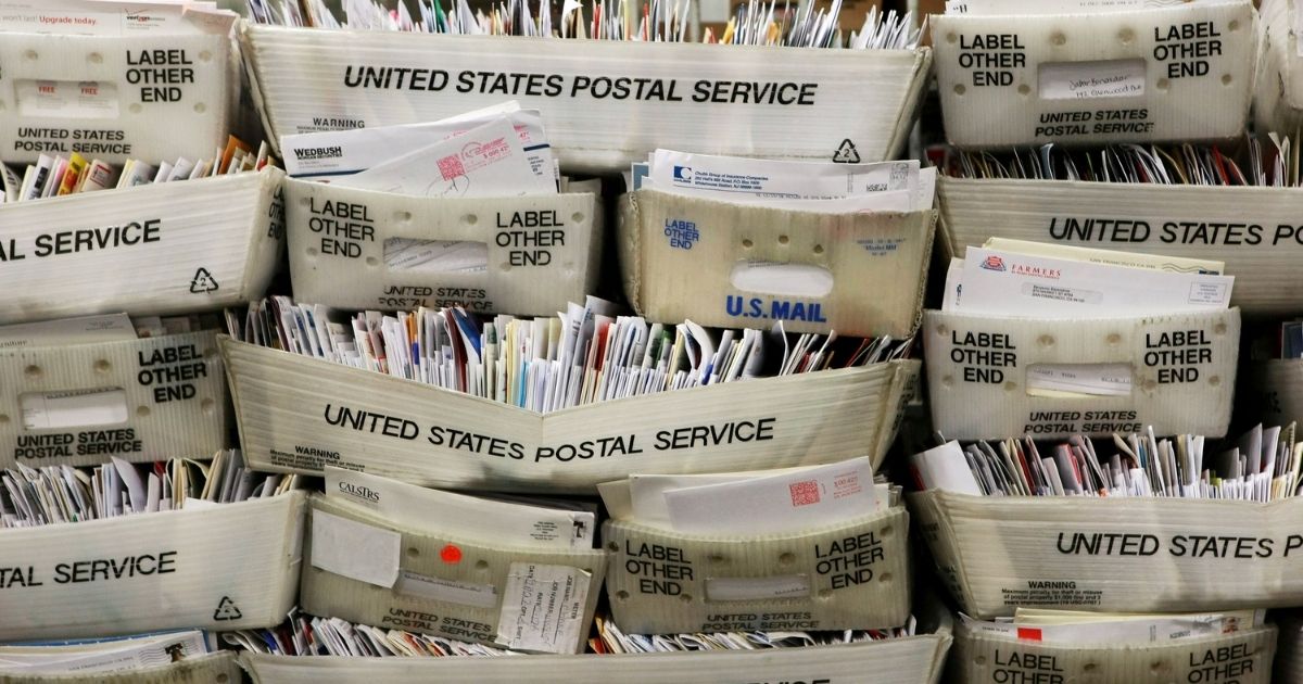 SAN FRANCISCO - DECEMBER 15: Stacks of boxes holding cards and letters are seen at the U.S. Post Office sort center December 15, 2008 in San Francisco, California. On its busiest day of the year, the U.S. Postal Service is expecting to process and mail over one billion cards, letters and packages.