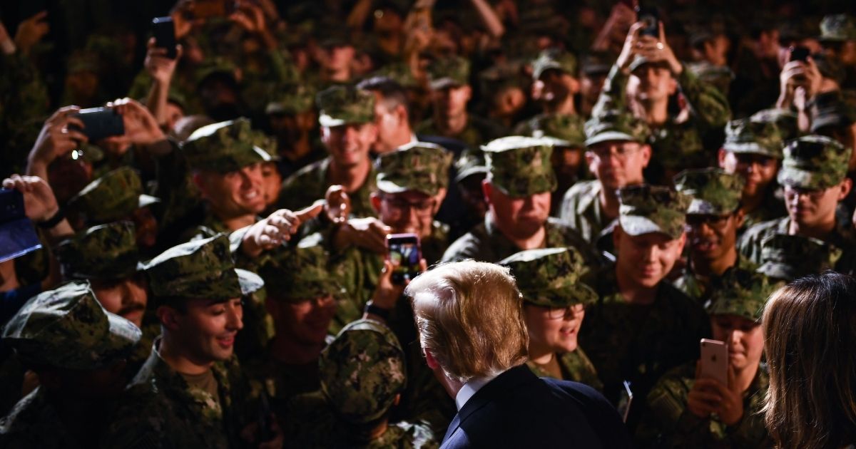 US President Donald Trump and First Lady Melania Trump greet Marines aboard the amphibious assault ship USS Wasp (LHD 1) during a Memorial Day event in Yokosuka on May 28, 2019.