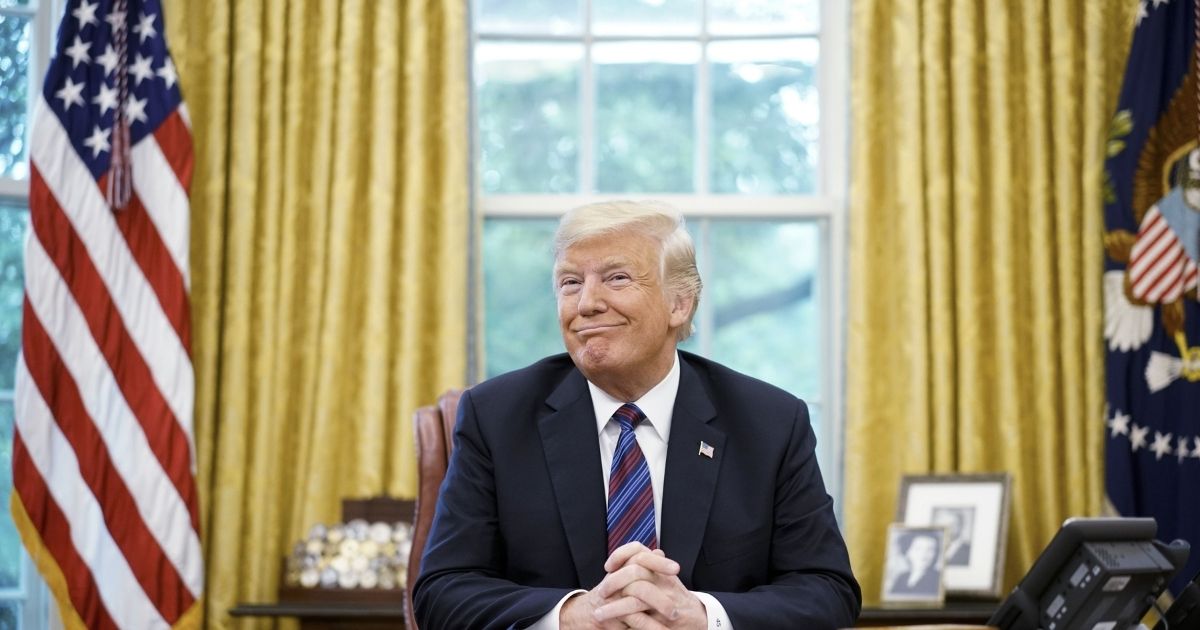 US President Donald Trump smiles during a phone conversation with Mexico's President Enrique Pena Nieto on trade in the Oval Office of the White House in Washington, DC on August 27, 2018. - President Donald Trump said Monday the US had reached a "really good deal" with Mexico and talks with Canada would begin shortly on a new regional free trade pact."It's a big day for trade. It's a really good deal for both countries," Trump said."Canada, we will start negotiations shortly. I'll be calling their prime minister very soon," Trump said.US and Mexican negotiators have been working for weeks to iron out differences in order to revise the nearly 25-year old North American Free Trade Agreement, while Canada was waiting to rejoin the negotiations.
