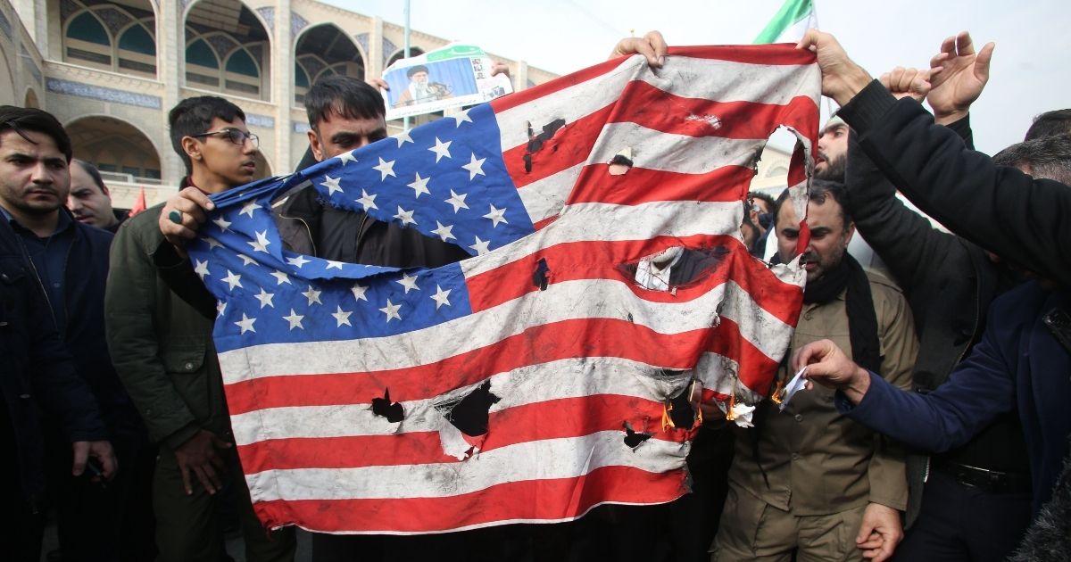 Iranians burn a US flag during a demonstration against American "crimes" in Tehran on January 3, 2020 following the killing of Iranian Revolutionary Guards Major General Qasem Soleimani in a US strike on his convoy at Baghdad international airport. - Iran warned of "severe revenge" and said arch-enemy the United States bore responsiblity for the consequences after killing one of its top commanders, Qasem Soleimani, in a strike outside Baghdad airport.