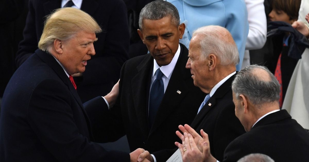 US President Donald Trump (L) shakes hands with former US President Barack Obama (C) and former vice-President Joe Biden after being sworn in as President on January 20, 2017 at the US Capitol in Washington, DC.