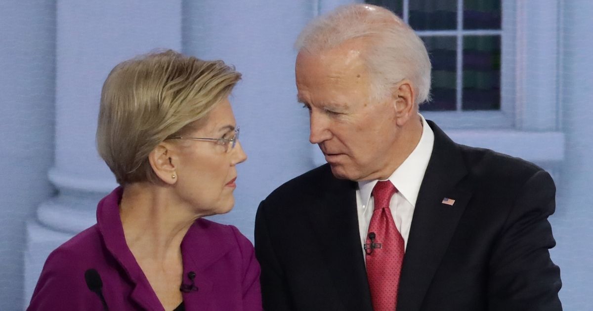 Massachusetts Sen. Elizabeth Warren and former Vice President Joe Biden speak during a break in the Democratic presidential primary debate at Tyler Perry Studios in Atlanta on Nov. 20, 2019.