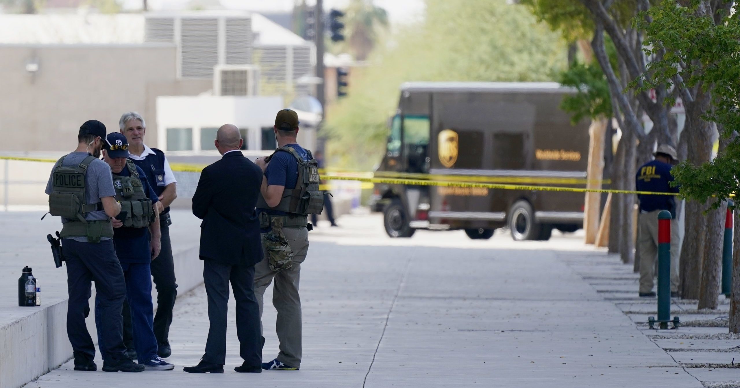 Federal law enforcement personnel stand outside the Sandra Day O'Connor Federal Courthouse on Sept. 15, 2020, in Phoenix. A drive-by shooting wounded a federal court security officer outside the courthouse in downtown Phoenix.