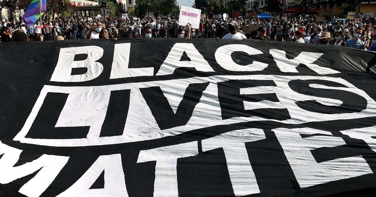 Protesters display a "Black Lives Matter" banner near the White House during a demonstration in Washington, D.C., on June 6, 2020.