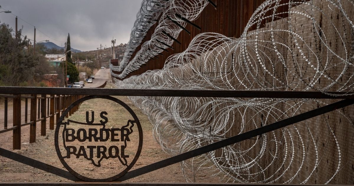 A metal fence marked with the U.S. Border Patrol sign is seen above in Nogales, Arizona, on Feb. 9, 2019.