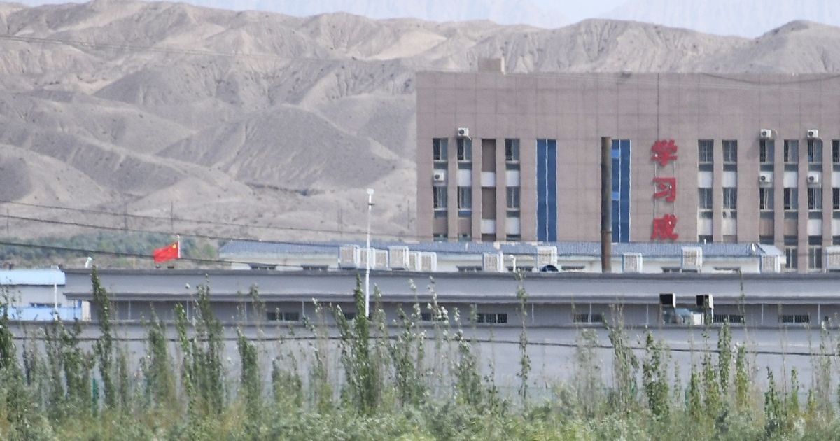 This photo taken on June 2, 2019, shows the Chinese flag and buildings at the Artux City Vocational Skills Education Training Service Center, believed to be an internment camp where mostly Muslim ethnic minorities are detained, in China's northwestern Xinjiang region.