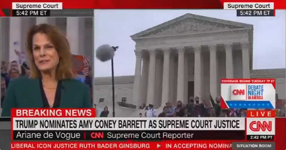 CNN correspondent Ariane de Vogue tries to report Saturday from the Supreme Court, but is drowned out by an angry crowd.