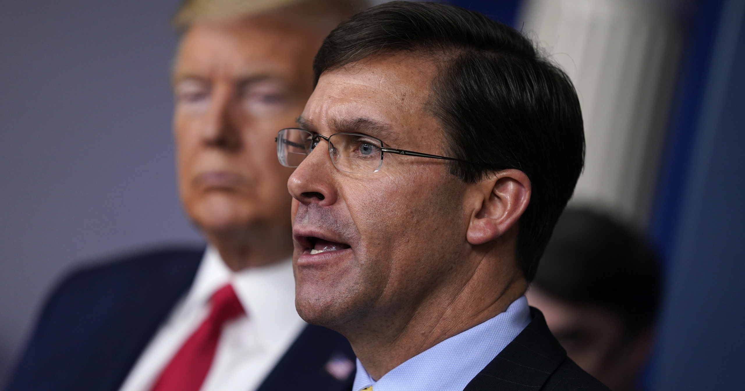 In this March 18, 2020, file photo, Defense Secretary Mark Esper speaks as President Donald Trump listens during a briefing at the White House in Washington, D.C.